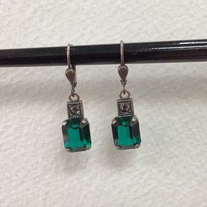 Green crystal dangle earrings with clear stone.